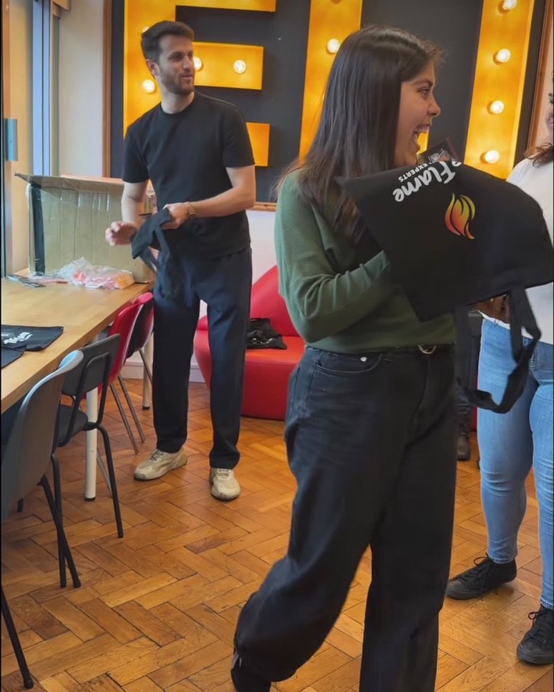 The Flame team handing out tote bags
